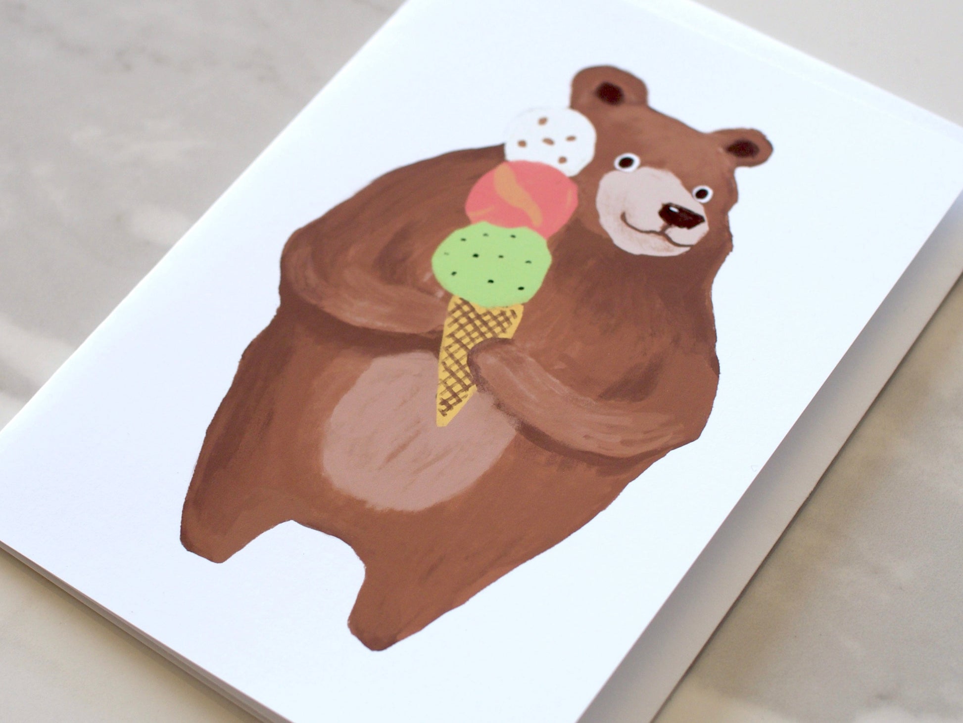 Card with a bear holding an ice cream cone on a white background