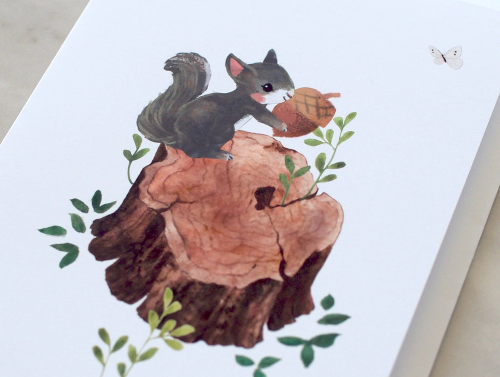 A greeting card featuring an illustration of a squirrel sitting on a wooden stump with leaves around it. The card is white, and there is a small butterfly flying in the top right corner of the image.