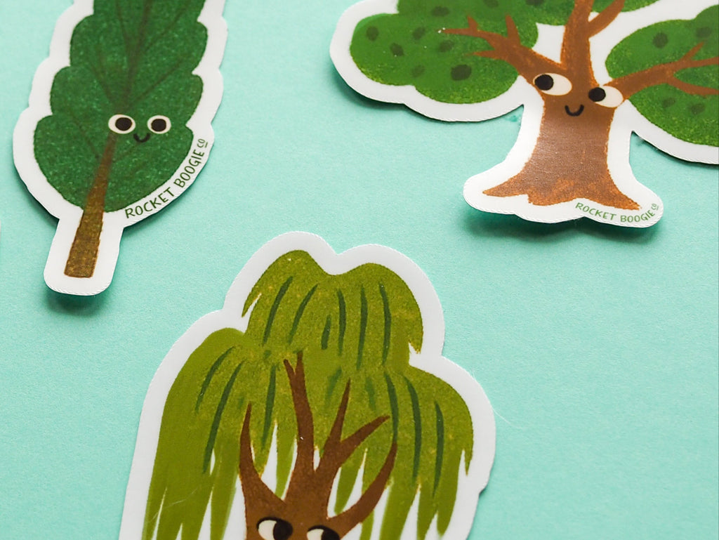 Sticker set of trees with faces on a light blue background