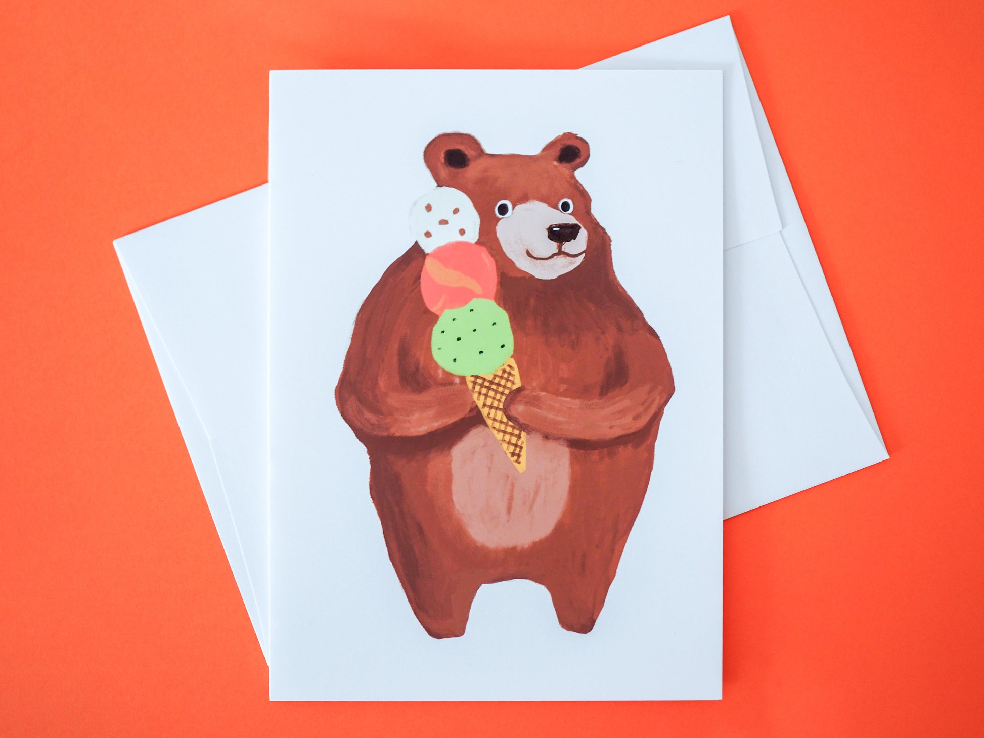 Card with a bear holding an ice cream cone on an orange background