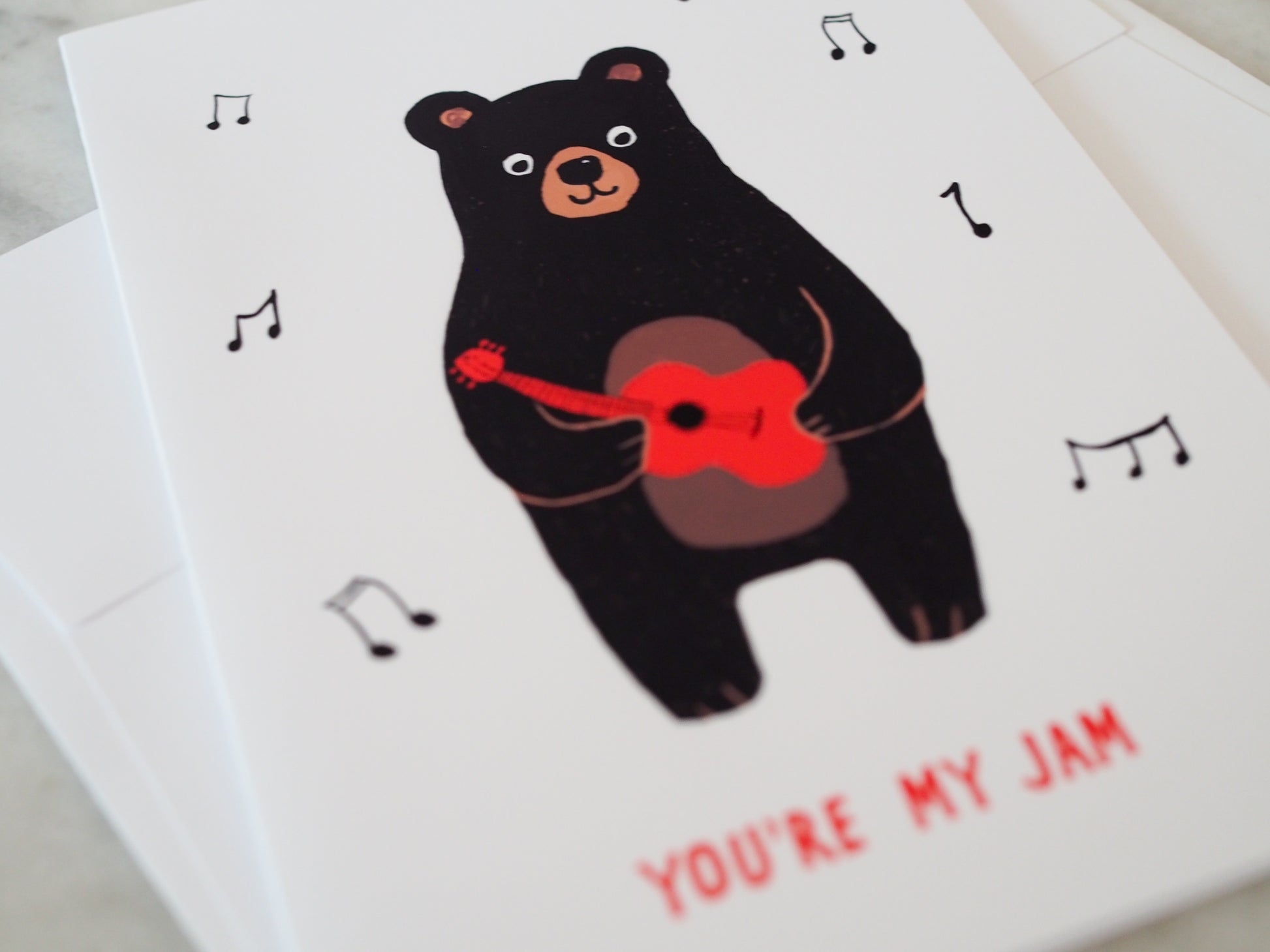 Card with a bear playing a guitar and 'You're My Jam' text on a white background