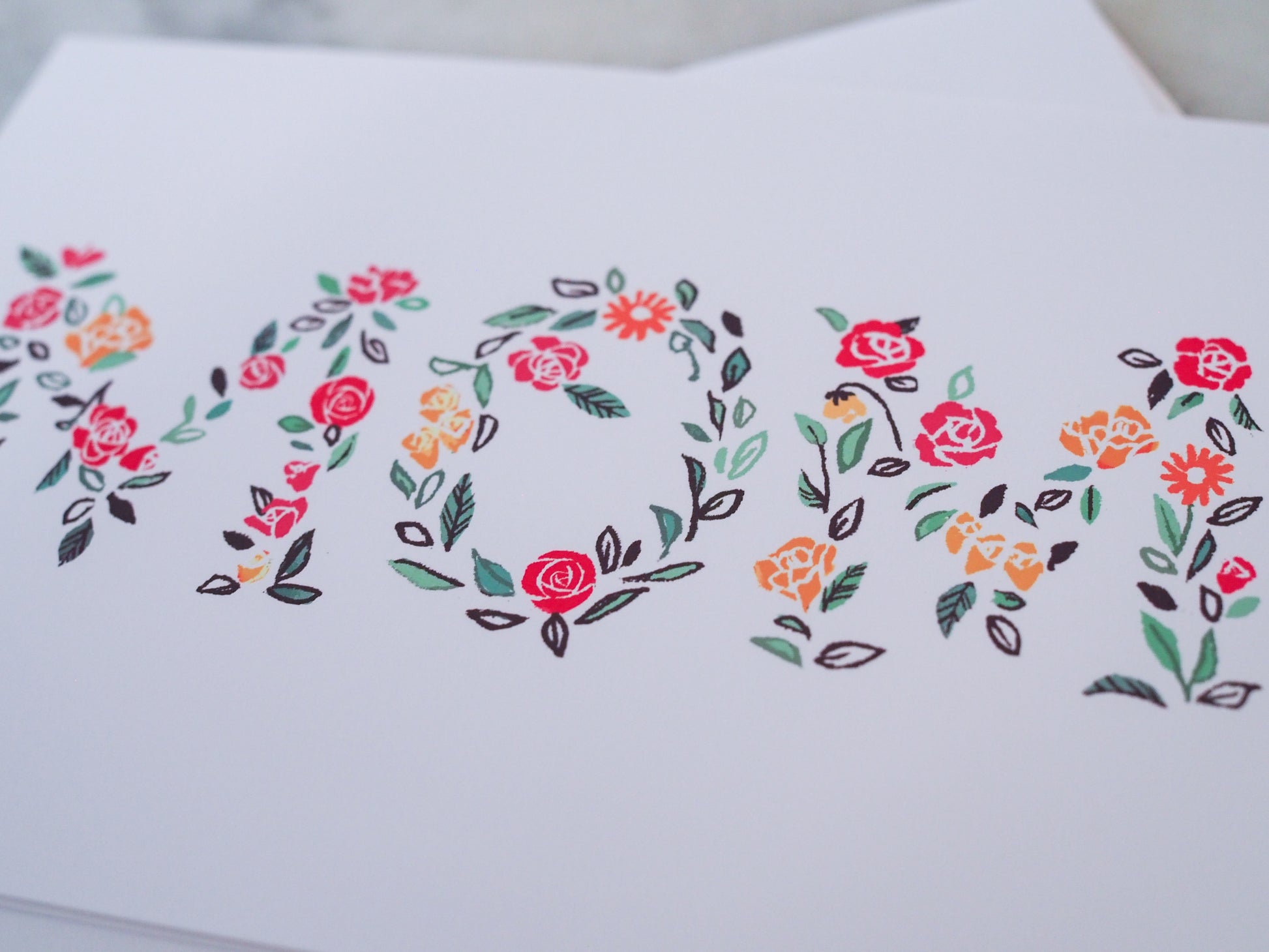 Floral design on a white card with a blurred background