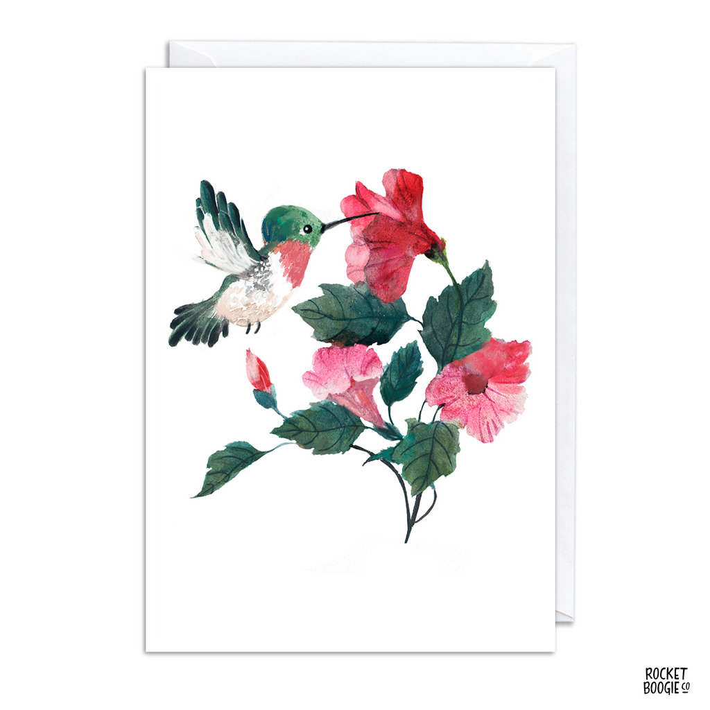 A greeting card featuring an illustration of a hummingbird with red and pink flowers.