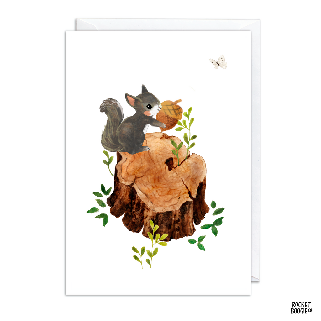 A greeting card featuring an illustration of a squirrel sitting on a wooden stump with leaves around it. The card is white, and there is a small butterfly flying in the top right corner of the image.